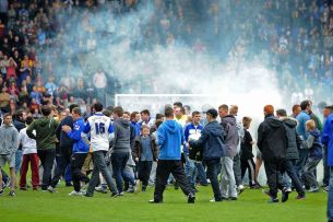 Upset fans invade the pitch after the final whistle and relegation is confirmed. Image courtesy of Liverpool Echo